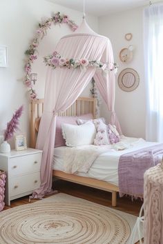 a pink canopy bed in a girls bedroom