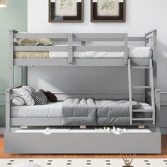 a bunk bed with two sets of mattresses on the bottom, and another set of drawers underneath