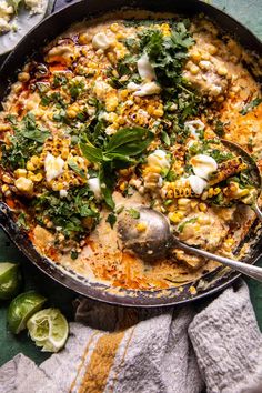 a skillet filled with mexican food and garnished with cilantro, jalapenos, and cheese