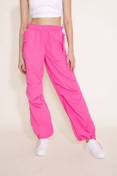 Step up your athletic game this with these Love Tree Nylon Baggy Parachute Pants for Women in Pink. These pants feature a comfy parachute design, elastic waistband, and side pockets to keep you comfortable all day long. These are going to be your new favorite pair of pants! Features: Love Tree Style: 6853PH-PINK Color: Pink 100% Nylon Women’s pants Side pockets Elastic waistband Moisture wicking Measurements from size small: Waist: 26” Front Rise: 11” Back rise: 13” Inseam: 31" Machine wash cold Trendy Sports Sweatpants With Elastic Waistband, Solid Baggy Sporty Cargo Pants, Pink Parachute Pants With Cargo Pockets For Streetwear, Techwear Sports Parachute Pants, Trendy Stretch Parachute Pants For Streetwear, Baggy Nylon Pants For Outdoor Activities, Sportswear Parachute Pants For Streetwear With Pockets, Nylon Long Pants With Functional Drawstring, Athleisure Parachute Pants With Loosely Fitted Hips