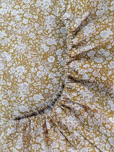 closeup of the ruffles on this yellow and white floral print bedding