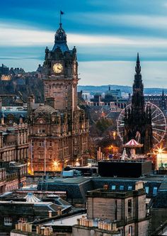 a large building with a clock on it's face in the middle of a city