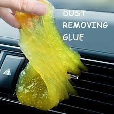 someone is cleaning the air conditioner with a yellow cloth on their car's dashboard