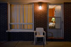 a white chair sitting in front of a window