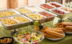 a table topped with lots of food and bowls filled with different types of toppings