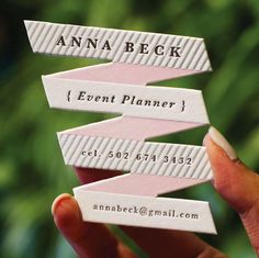 a person holding up some business cards in their hand with the words event planner printed on them