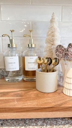 bathroom items displayed on wooden counter in white and gold decorating theme with christmas tree