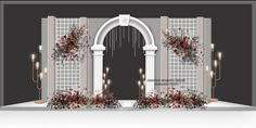 an arch with flowers and candles in front of it