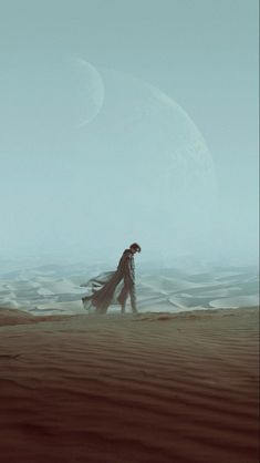 a man walking across a desert covered in sand next to a giant moon and distant planet