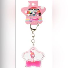 a pink keychain with a cartoon character in the shape of a star on it