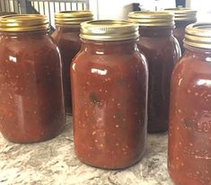 several jars filled with food sitting on top of a counter