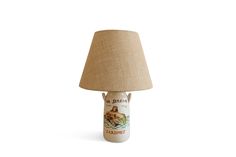 a lamp that is sitting next to a white wallpaper with an image of a dog on it