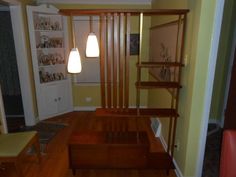 a living room with yellow walls and wooden stairs