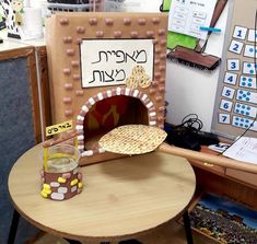 a wooden table topped with a small pizza oven