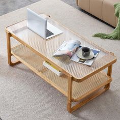 a coffee table with magazines and a laptop on it