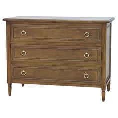 a wooden dresser with three drawers and two pulls on the bottom drawer, against a white background