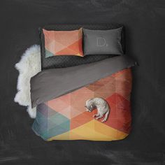 a bed with a cat on it and some pillows