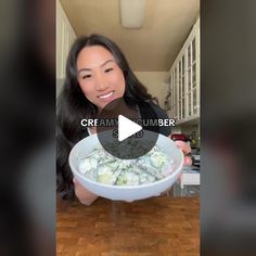 a woman holding a bowl filled with food