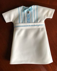 a baby's white shirt with blue stripes and a bow tie on the collar