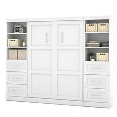 a white bookcase with two doors and three drawers on each side, in front of a