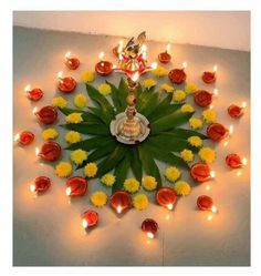 an arrangement of flowers and candles arranged in the shape of a kaleikabob