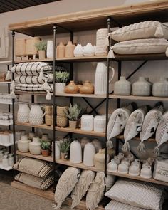 the shelves are filled with different types of pottery