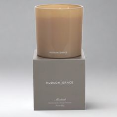 a candle sitting on top of a box with the words hudson grace written in it