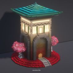 a small building made out of legos and flowers