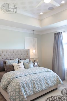 a bedroom with a large bed and blue comforter