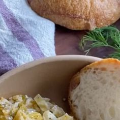 a bowl filled with pasta and bread on top of a table