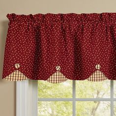 a window with a red and white checkered valance