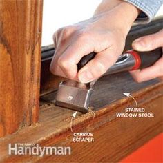 a person is using a stapler to attach the window seal on a wooden frame