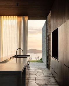 an open kitchen with stone flooring and walls