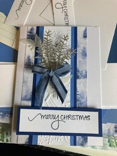 some cards with blue and white designs on them, one has a bow at the top