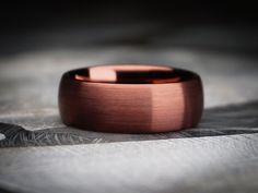 a close up of a wedding ring on a feathery surface with only the center piece visible