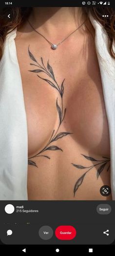 a woman's chest with tattoos on it