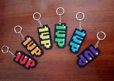 six pixel keychains with the word mine written in different colors and sizes on them