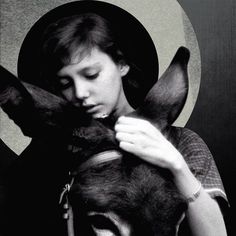 a woman holding a dog in front of her face with the letter o on it