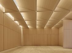 an empty room with wooden walls and ceiling