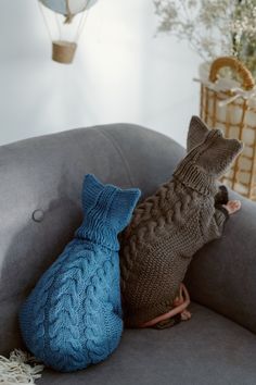 two knitted animals sitting on a couch