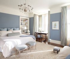 an image of a bedroom with blue walls and chandelier hanging from the ceiling