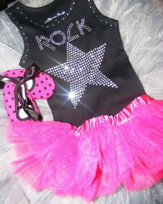 a black tank top with pink and white polka dot tutu skirt is on display