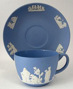 a blue cup and saucer sitting next to each other