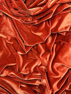 an orange fabric with very long folds