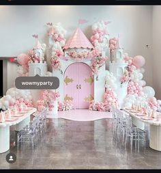 a pink and white castle themed birthday party with balloons, tables, chairs and decorations