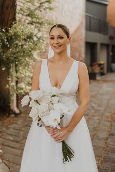 a woman in a wedding dress holding a bouquet