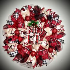 a wreath with the word no elf on it and ornaments around it in red, white and black