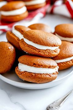 several cookies with white frosting on a plate