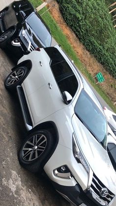 two cars parked next to each other in a parking lot