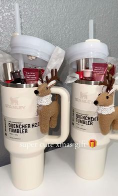 two coffee cups with reindeer mugs in them